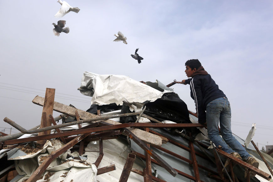 A Palestinian inspects the rubble of a farm that was demolished after Israeli authorities said it was built without a permit on Monday in the West Bank village of Al Fundoq, east of the village of Qalqiliya (AFP photo)