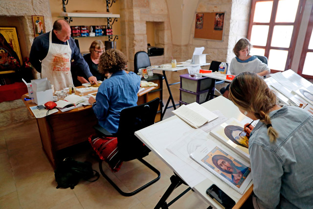 Ian Knowles (left), British director of the Bethlehem Icon Centre, advises foreign students of the centre during their course in the biblical West Bank city of Bethlehem on Tuesday (AFP photo)