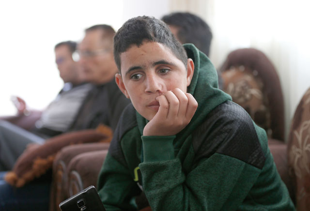 Palestinian Mohammed Tamimi, 15, sits at his family home in the West Bank city of Ramallah on Tuesday (AFP photo)