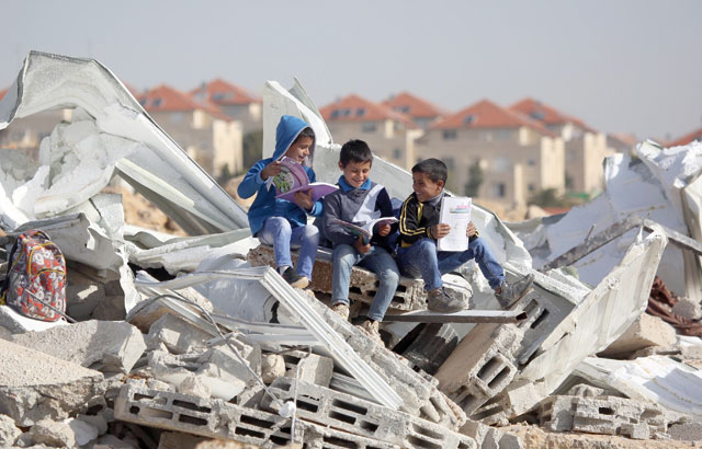Students of Abu Al Nuwar Primary School are seen as they continue to study on the debris of their school building after Israeli forces have demolished some of the classrooms on the grounds that the school was unlicensed in Jerusalem on Sunday (Anadolu Agency photo)