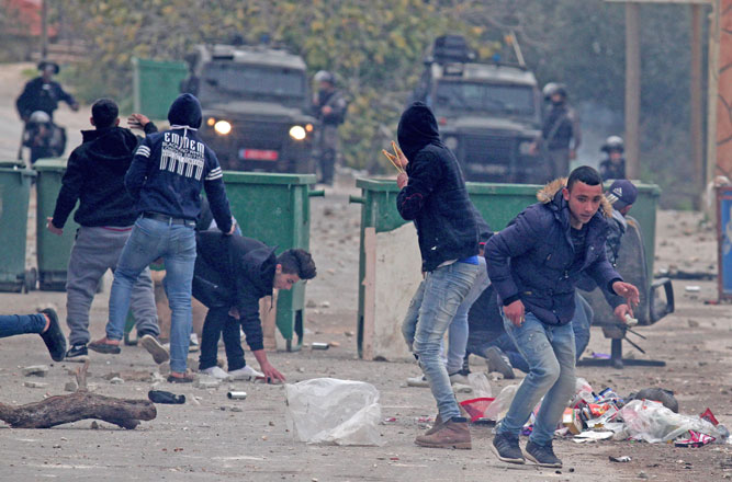 Palestinians confront with Israeli forces during a protest after Palestinian Ahmed Jarrar, accused of killing an Israeli settler last month, was killed by Israeli forces in the occupied West Bank, on Tuesday, in Jenin, the West Bank (Anadolu Agency photo)