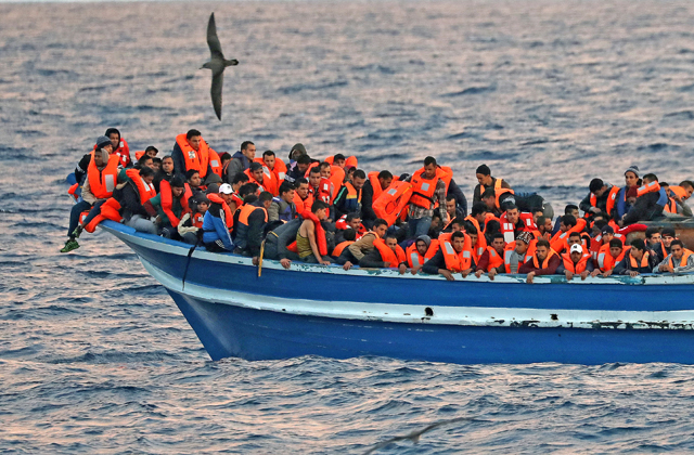 Migrants overcrowd a wooden vessel during a rescue operation by the Spanish NGO Pro-Activa Open Arms in central Mediterranean Sea off the Libyan coast, on Wednesday (Reuters photo)