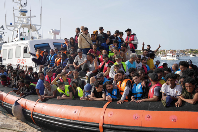 Migrants arrive in the harbour of Italian island of Lampedusa on Monday (AFP photo)
