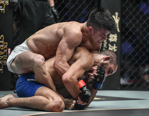Mark Striegl of the Philippines (left) fights Sotir Kichukov of Bulgaria during their ONE Championship mixed martial arts bout at Mall of Asia Arena in Manila, on December 2, 2016  (AFP photo by David Ash)