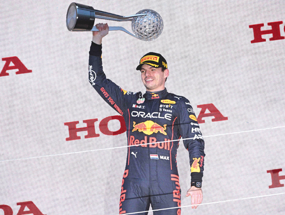 Red Bull Racing’s Dutch driver Max Verstappen poses on the podium with the trophy following his victory at the Formula One Japanese Grand Prix at Suzuka on Sunday (AFP photo by Philip Fong)