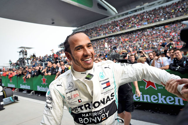 Mercedes’ British driver Lewis Hamilton celebrates after winning the Formula One Chinese Grand Prix in Shanghai on Sunday (AFP photo by Wang Zhao)