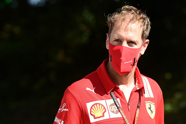 Ferrari's German driver Sebastian Vettel wears a protective face mask as he visits the track with team members at the Autodromo Nazionale circuit in Monza ahead of the Italian Formula One Grand Prix on September 3 (AFP photo by Miguel Medina)