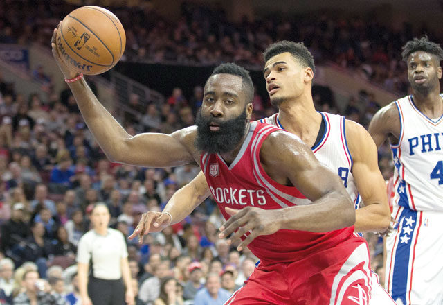 Houston Rockets guard James Harden controls a rebound past Philadelphia 76ers guard Timothe Luwawu-Cabarrot during their NBA game on Friday in Philadelphia  (Reuters photo by Bill Streicher)