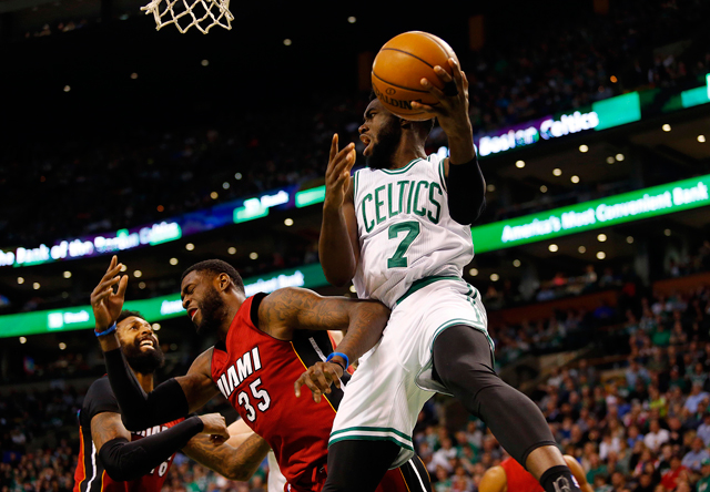Celtics forward Jaylen Brown looks to pass the ball past Miami Heat forward Willie Reed during their NBA game in Boston on Sunday  (Reuters photo by Winslow Townson)