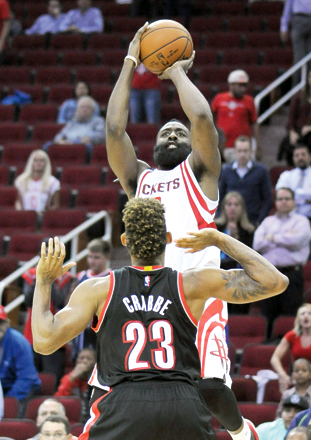 Houston Rockets’ James Harden shoots a three-point shot over Portland Trail Blazers’ Allen Crabbe in overtime of an NBA basketball game in Houston, on Wednesday (AP photo by Pat Sullivan)