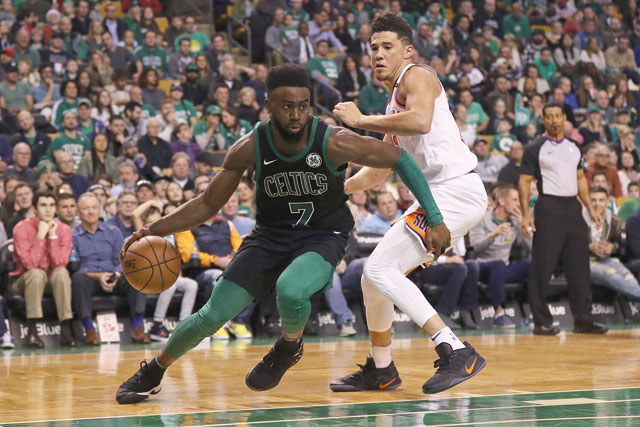 Jaylen Brown of the Boston Celtics drives against Devin Booker of the Phoenix Suns during their NBA game in Boston, Massachusetts, on Saturday (AFP photo by Maddie Meyer)