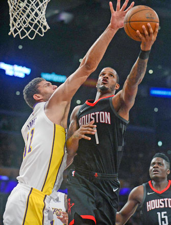 Houston Rockets forward Trevor Ariza moves to the basket against Los Angeles Lakers centre Brook Lopez during their NBA game in Los Angeles, California, on Sunday (Reuters photo by Gary A. Vasquez)