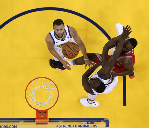 James Harden of the Houston Rockets throws up a shot against Draymond Green (centre)  and Stephen Curry of the Golden State Warriors during Game 3 of the Western Conference finals of the 2018 NBA play-offs in Oakland, California, on Sunday (AFP photo by Ezra Shaw)