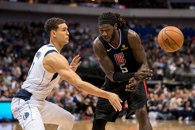 Dallas Mavericks forward Dwight Powell knocks the ball out of the hands of LA Clippers forward Montrezl Harrell during their NBA game in Dallas, Texas, on Sunday  (Reuters photo by Jerome Miron)