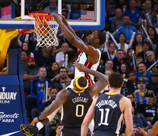 Miami Heat centre Bam Adebayo dunks the ball above Golden State Warriors centre DeMarcus Cousins during their NBA game in Oakland, California, on Sunday (Reuters photo by Kelley L Cox)