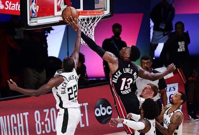 Khris Middleton of the Milwaukee Bucks blocks a shot by Bam Adebayo of the Miami Heat during the 2020 NBA play-offs in Lake Buena Vista, Florida, on Sunday  (AFP photo by Douglas P. DeFelice)