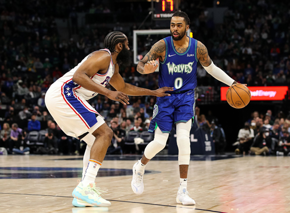 D’Angelo Russell of the Minnesota Timberwolves dribbles the ball while James Harden of the Philadelphia 76ers defends during their NBA game in Minneapolis, Minnesota, on Friday (AFP photo by David Berding)
