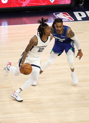 Memphis Grizzlies’ Ja Morant dribbles while Minnesota Timberwolves’ D’Angelo Russell defends during Game Six of the Western Conference in Minneapolis, Minnesota, on Friday (AFP photo by David Berding)
