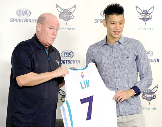 Charlotte Hornets’ basketball coach Steve Clifford (left) holds a jersey with newly acquired point guard Jeremy Lin during a news conference in Charlotte on Monday (AP photo by David T. Foster)