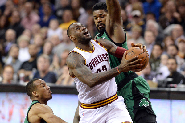 Cleveland Cavaliers forward LeBron James drives to the basket between Boston Celtics guard Avery Bradley and forward Amir Johnson during their NBA game in Cleveland on Saturday (Reuters photo by Ken Blaze)