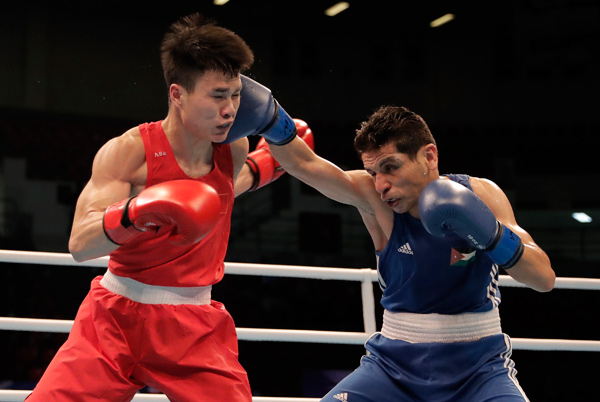 Jordan’s Mohammad Al Wadi takes on Van Duong Nguyen of Vietnam during their Featherweight 57kg match at the Asian/Oceanian Olympic Boxing qualifiers in Amman on Tuesday  (Photo courtesy of the Jordan Olympic Committee News Service)