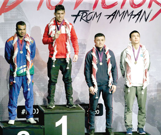 Jordan’s Zeyad Ishaish (2nd left) stands on the podium after winning the gold medal for the Welterweight 69kg division final match at the Asian/Oceanian Olympic Boxing qualifiers in Amman on Wednesday (Photo courtesy of the Jordan Olympic Committee News Service)