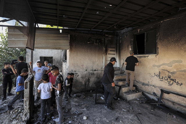 Locals inspect a home that was hit by Israeli fire during a raid earlier in Jenin, in the north of the occupied West Bank, on Wednesday (AFP photo)