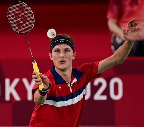 Denmark’s Viktor Axelsen hits a shot to China’s Chen Long in their men’s singles badminton final match during the Tokyo 2020 Olympic Games in Tokyo on Monday  (AFP photo by Pedro Pardo)