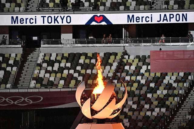 The Olympic Cauldron and the Olympic flame is photographed during the closing ceremony of the Tokyo 2020 Olympic Games, on Sunday at the Olympic Stadium in Tokyo  (AFP photo by Jewel Samad)