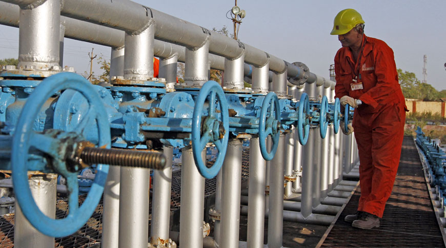 A technician opens a pressure gas valve inside the Oil and Natural Gas Corp. group gathering station on the outskirts of Ahmedabad on March 2, 2012 (Reuters photo)