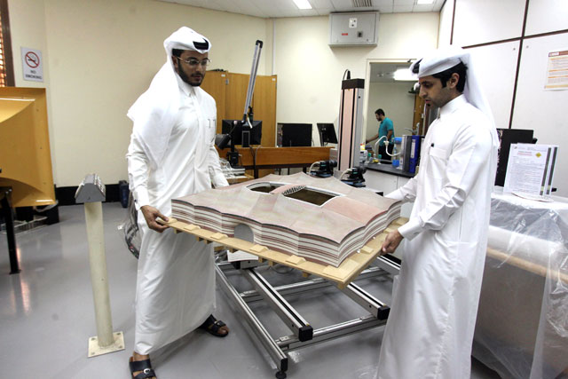 Mechanical engineers Abdullah Mojeb Aldar (left), 26, and Fahad Al Musalam, 24, move a 3D-printed model of Qatar's Al Bayt stadium, which will host a World Cup semifinal in 2022, at a laboratory at Qatar University in Doha, Qatar, June 16 (Reuters photo)
