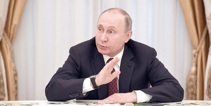 Russian President and presidential candidate Vladimir Putin meets with other candidates in the poll, a day after the presidential election, at the Kremlin, in Moscow, on Monday (AFP photo)
