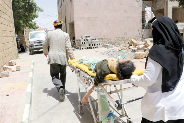 A school girl is being rushed on a stretcher to a hospital after she was injured by an air strike near her school in Saada, Yemen, on Monday (Reuters photo)