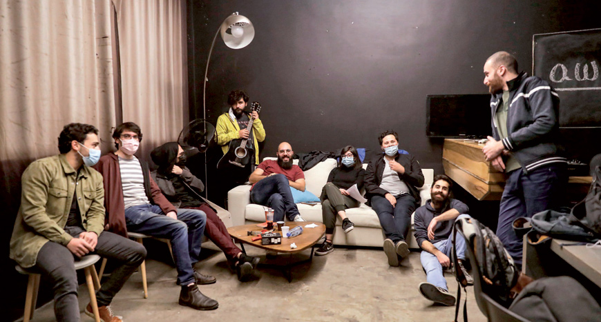Stand-up comedians taking part in a night organised by the ‘Awk.word’ platform exchange ideas backstage ahead of their show at the KED Beirut venue in the Lebanese capital’s Karantina neighbourhood on Tuesday (AFP photo)