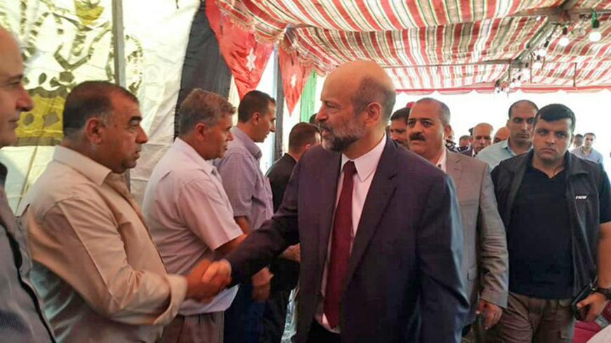 Prime Minister Omar Razzaz pays condolences to the family of fallen officer Corp. Mohammad Hayajneh near Irbid on Sunday   (Petra photo)