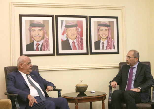 Minister of Foreign Affairs and Expatriates Ayman Safadi meets with Saeb Erekat, secretary general of the Palestine Liberation Organisation’s  executive committee, on Saturday. The two officials discussed possible ways of coordinating joint Arab action and stressed the need for a firm international stance on the issue  (Photo courtesy of the Ministry of Foreign Affairs)