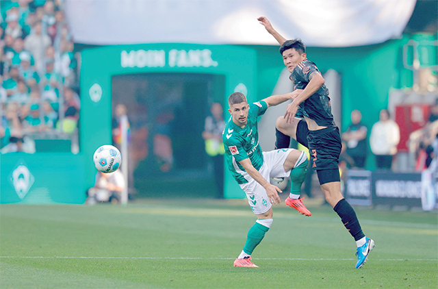 Bremen’s Austrian midfielder #20 Romano Schmid (left) and Bayern Munich’s French defender #02 Dayot Upamecano vie for the ball during the German first division Bundesliga football match between SV Werder Bremen and FC Bayern Munich in Bremen, northern Germany, on Saturday (AFP photo)