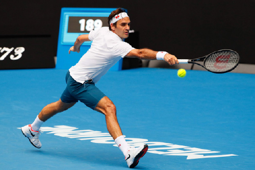 Switzerland’s Roger Federer hits a return against Britain’s Daniel Evans during their men’s singles match at the Australian Open tournament in Melbourne on Wednesday (AFP photo by David Gray)