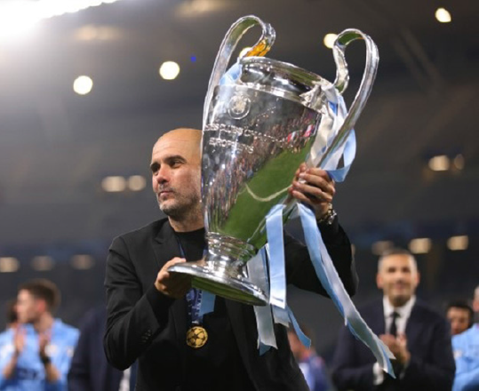 Pep Guardiola manager of Manchester City holds the Champions League trophy (AFP photo by Marc Atkins)