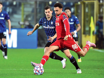 Liverpool’s English defender Trent Alexander-Arnold kicks the ball against Atalanta Bergamo during their UEFA Champions league match in Bergamo, Italy, on Tuesday  (AFP photo by Miguel Medina)