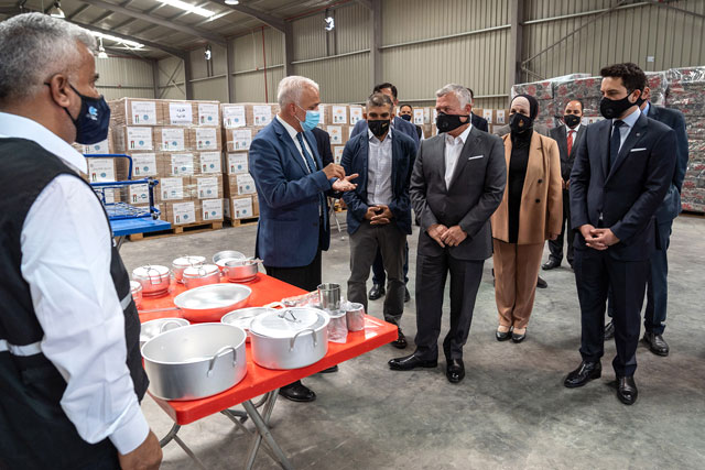 His Majesty King Abdullah, accompanied by HRH Crown Prince Hussein, visits the Jordanu2028Hashemite Charity Organisation’s warehouses in Ghabawi on Monday (Photo courtesy of Royal Court)
