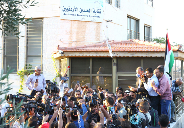 Journalists gather around the Jordan Teachers Association's spokesperson following a meeting of the syndicate's council on Thursday (Photo by Sahem Rababaah)