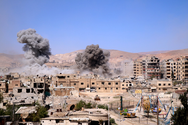 Smoke rises after Assad regime forces carried out air strikes in Eastern Ghouta’s Douma town in Damascus, Syria, on Saturday (Anadolu Agence photo)