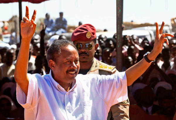 Sudan's prime minister Abdalla Hamdok flashes the victory sign upon arriving at a camp for internally displaced people  in Al Fasher, the capital of the North Darfur state, on Monday (AFP photo)