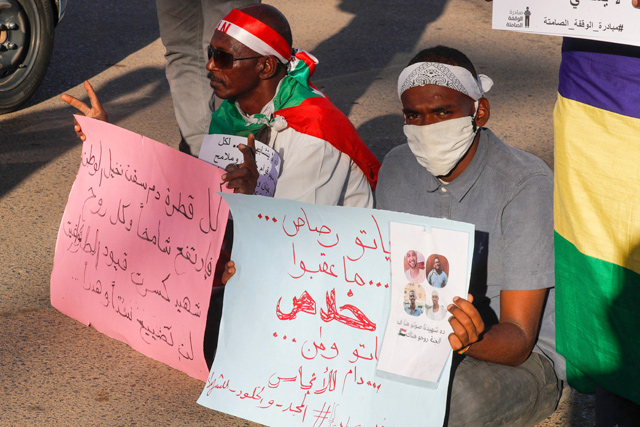 In this file photo relatives of slain protesters raise placards as families take part on January 3, in a sit-in on Nile Street in the Sudanese capital Khartoum, to pay tribute to killed anti-regime demonstrators (AFP photo)