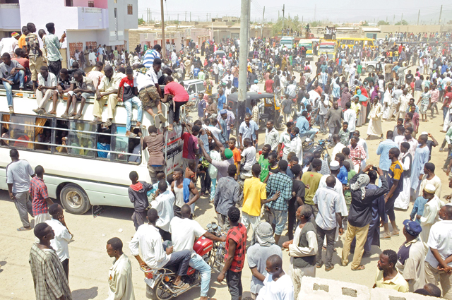 Scores of Hausa people gather outside local government offices in Port Sudan, on the Red Sea, on Tuesday to demand justice for comrades killed in a deadly land dispute with a rival ethnic group in the country's south (AFP photo)