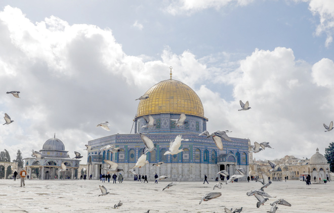 People walk outside the Dome of the Rock Mosque inside Jerusalem's Al Aqsa Mosque compound, Islam's third most holy site, on Friday (AFP photo)