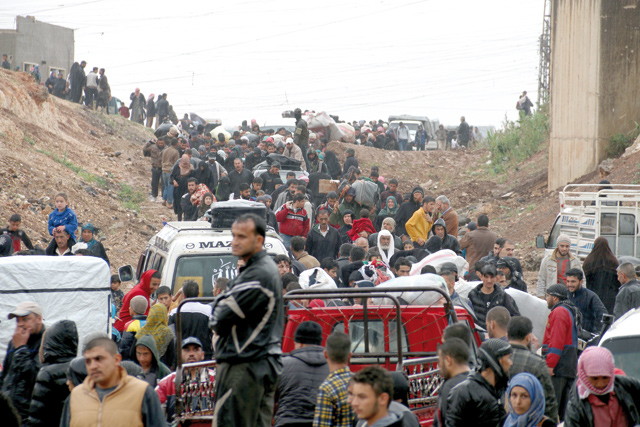 Syrian people wait to be evacuated in Al Rastan town of Homs to Al Bab district of Syria on Tuesday (Anadolu Agency  photo)