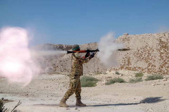 A fighter from the Third Legion of the Turkish-backed Free Syrian Army takes part in a military training exercise near the border town of Azaz in the rebel-held north of the Aleppo province on Thursday (AFP photo)