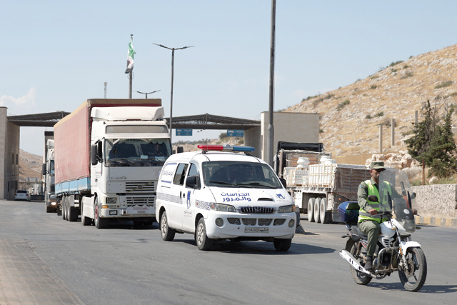 A convoy carrying humanitarian aid arrives in Syria after crossing the Bab Al Hawa border crossing with Turkey on Tuesday (AFP photo)